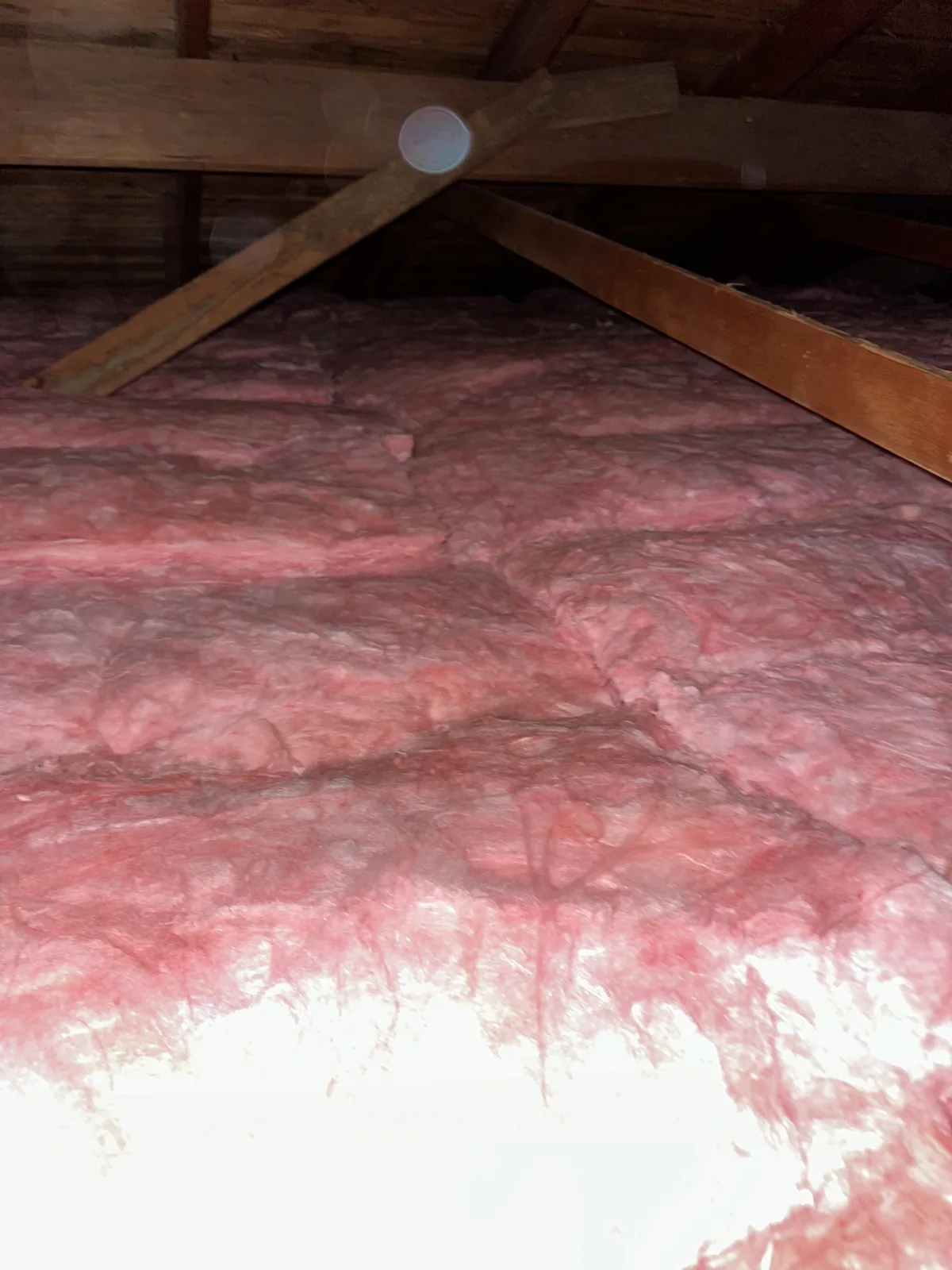 Fiberglass batt insulation fit around attic framing in Granada Hills